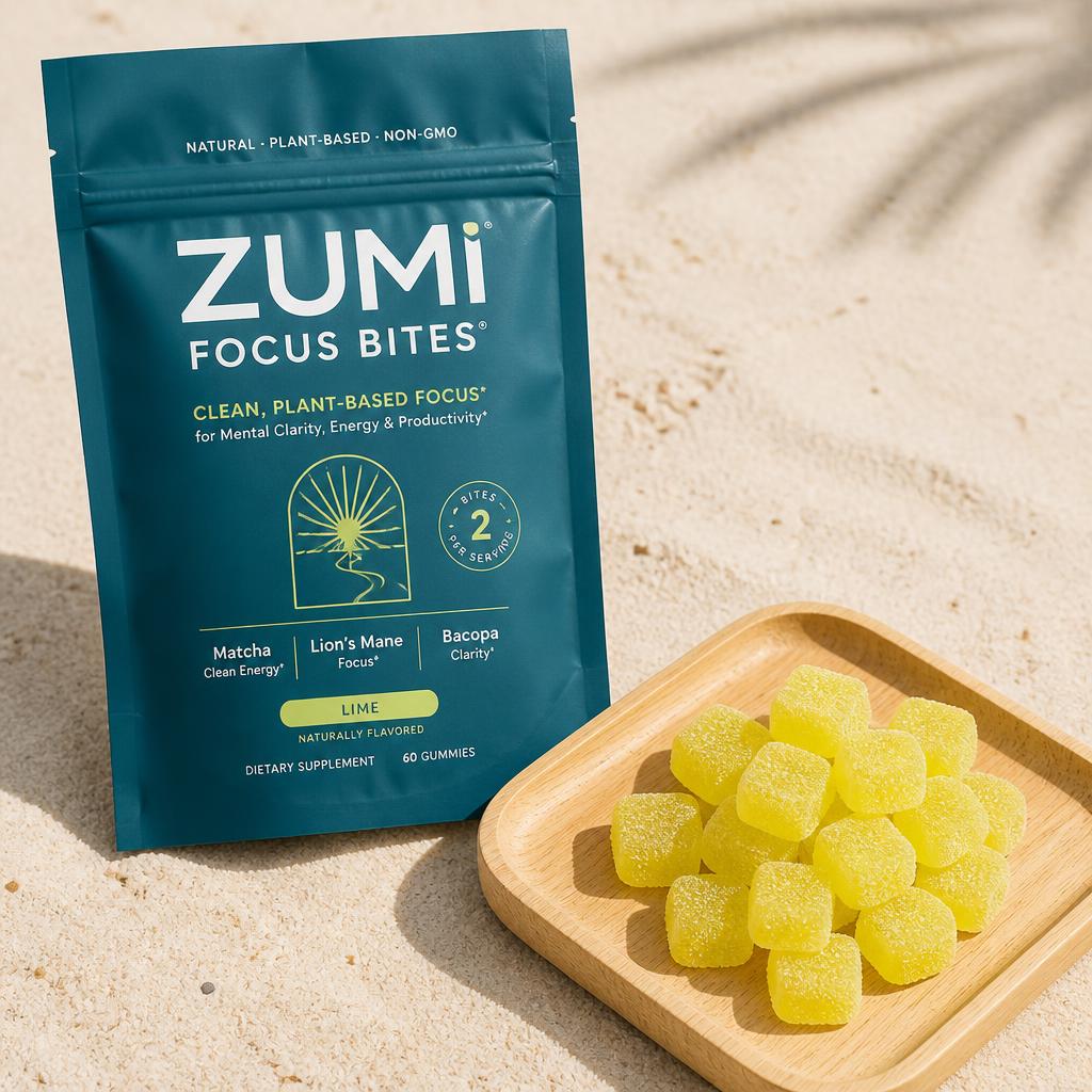 Zumi pouch beside a wooden tray of Focus Bites gummies